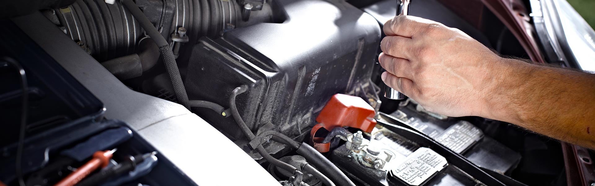 Service Technician replacing a car battery 