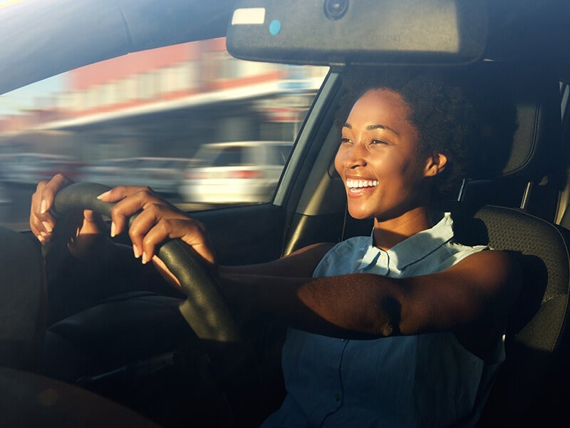 Smiling woman driving a car