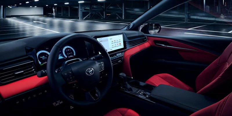 Interior of a car with a modern dashboard and red leather seats