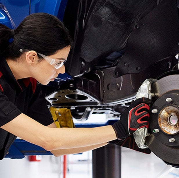 A Toyota service technician working on a Free Vehicle Repairs in conjunction with Elora J Khan Foundation in Ardmore, PA