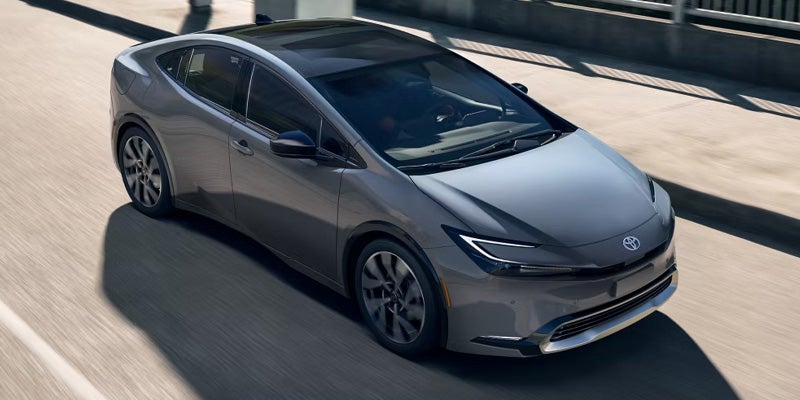 2025 Toyota Prius Plug-in Hybrid driving on a city street