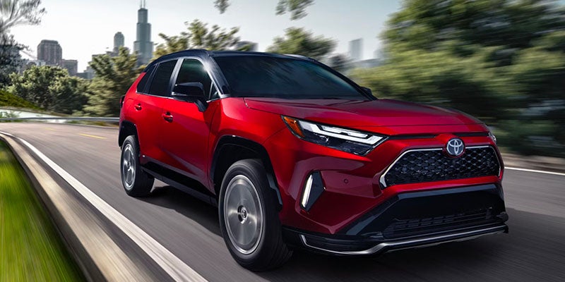 A 2025 Toyota RAV4 Plug-in Hybrid zooming down the road in Ardmore, PA 