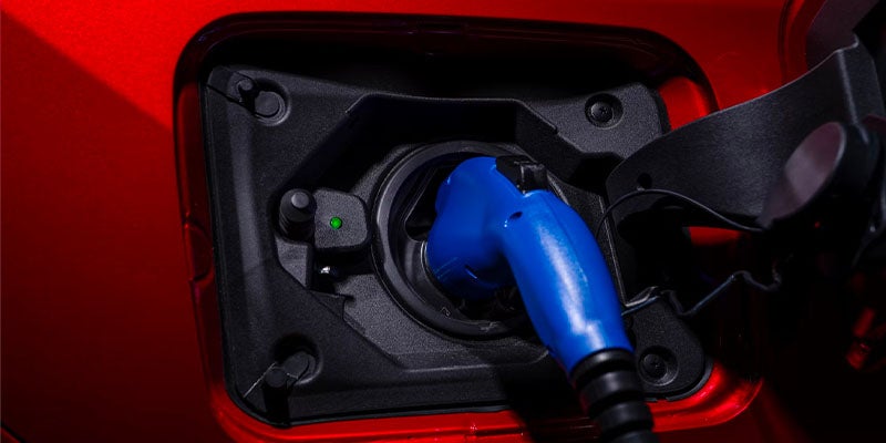 A 2025 Toyota RAV4 Plug-In Hybrid plugged in and charging in Ardmore, PA 