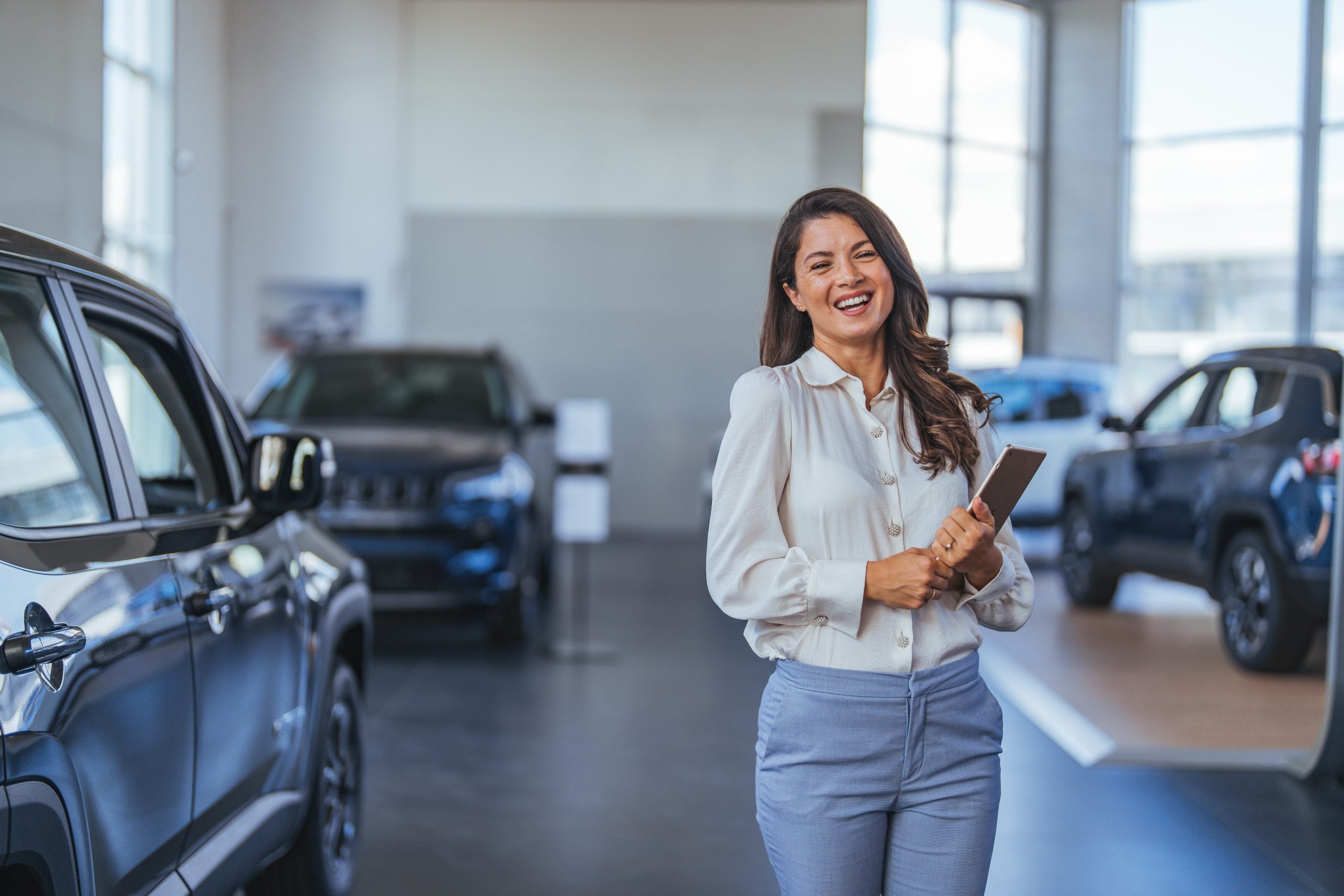 Happy customer in car showroom environment