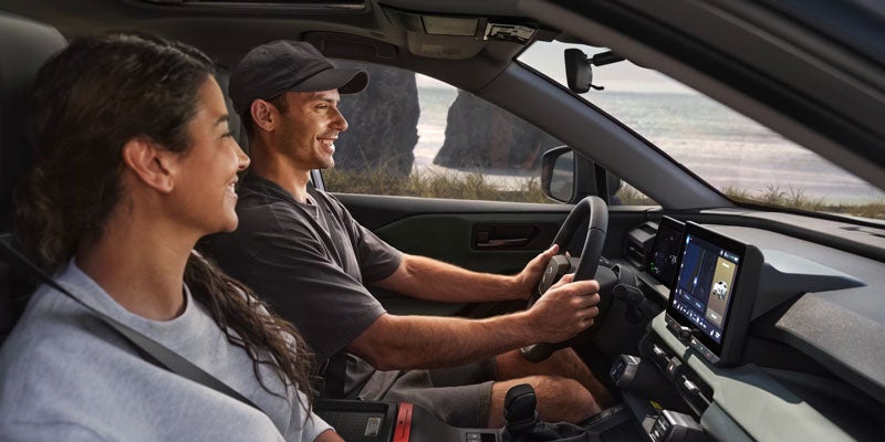 Couple enjoying a scenic drive inside SUV