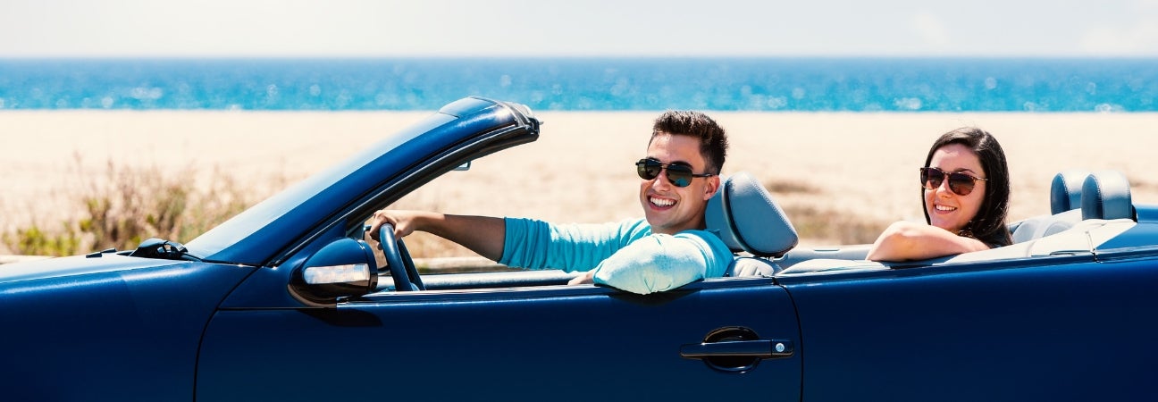 new owners celebrate convertible purchase by driving with the top down