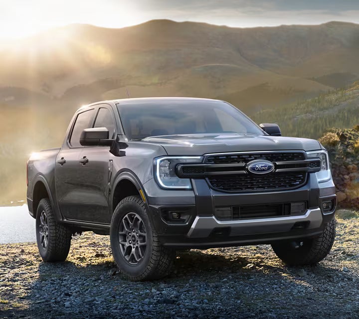 a 2025 black Ford Ranger truck is parked outside with mountains in the background near McMinnville, OR.