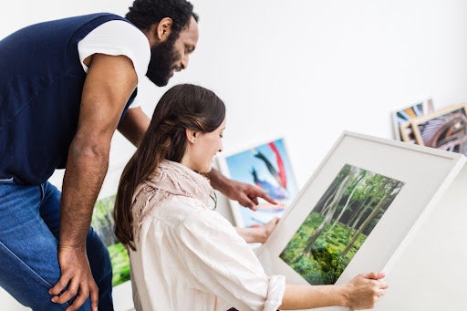 Young couple in art gallery looking at artwork.