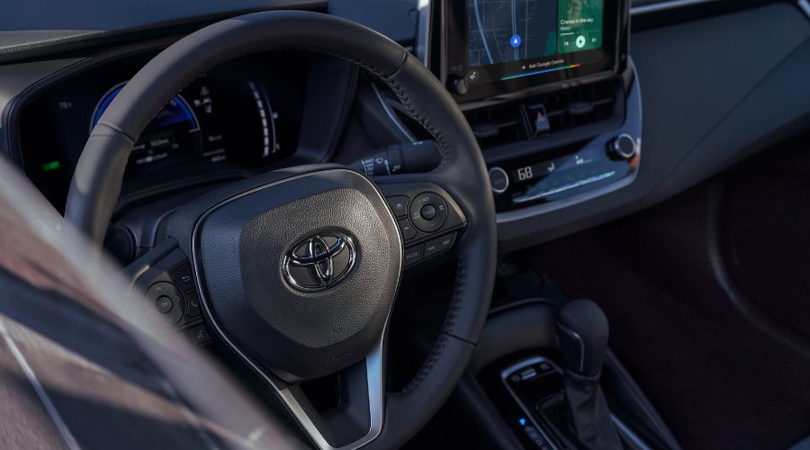 New 2027 Toyota Corolla SE sedan in dark Inked paint exterior with dark alloy wheels parked at an outdoor skatepark near Waukegan, IL, available now at Classic Toyota.