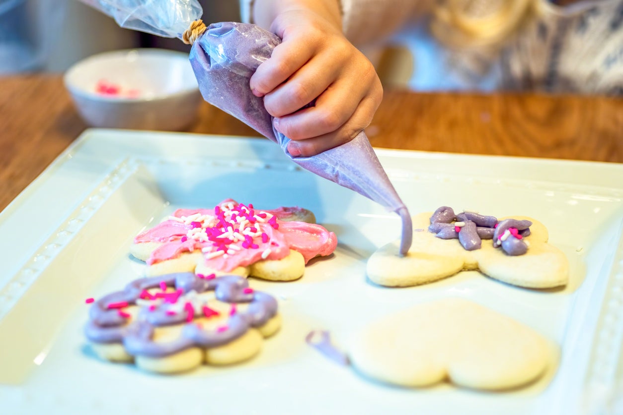 Closeup of child icing cookies