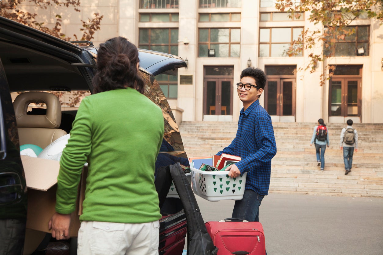 Young man moving into dormitory on college campus