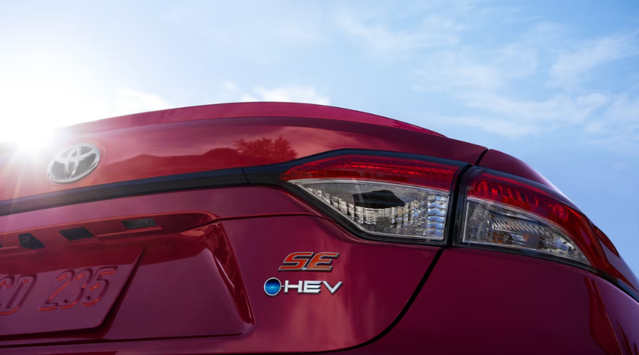 Close-up of the red 2026 Toyota Corolla SE HEV badge and hybrid taillight, showcasing class-leading efficiency for Gurnee and Waukegan, IL commuter cars.