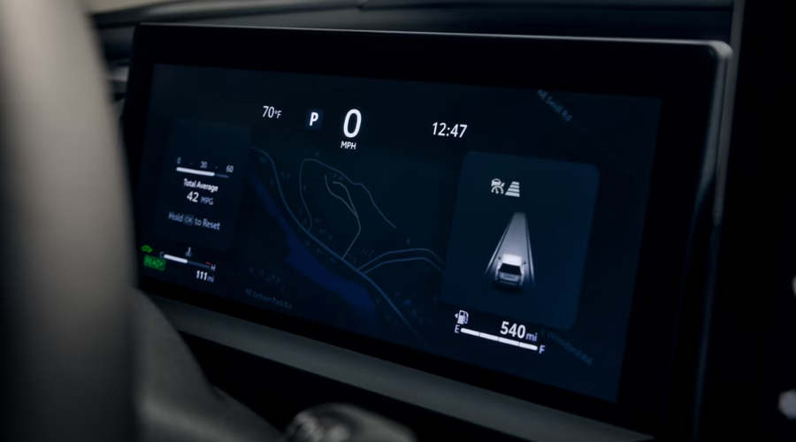 Close-up of the 2026 Toyota RAV4 digital instrument cluster displaying Proactive Driving Assist safety graphics, 42 MPG hybrid fuel economy, and 540 miles of total range for a Lake County commute near Waukegan, IL.