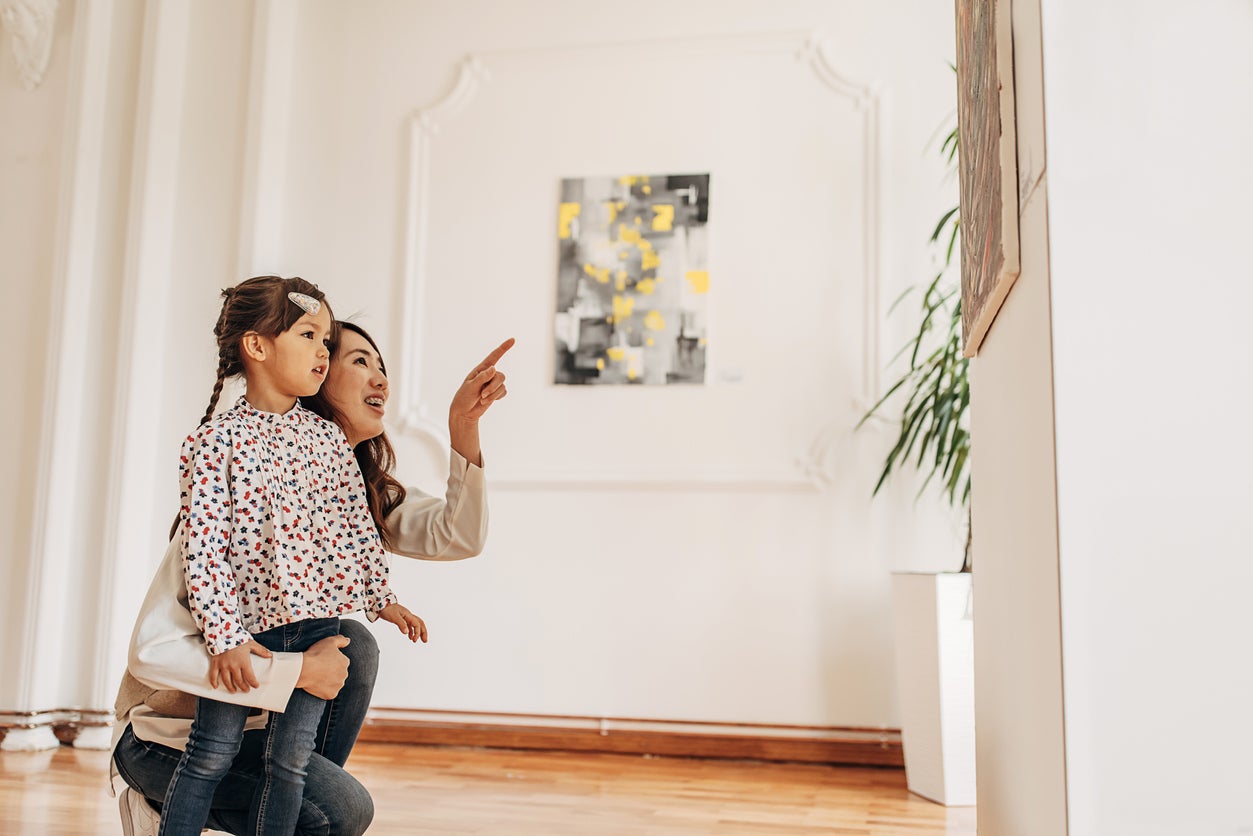 Mother and daughter in art gallery