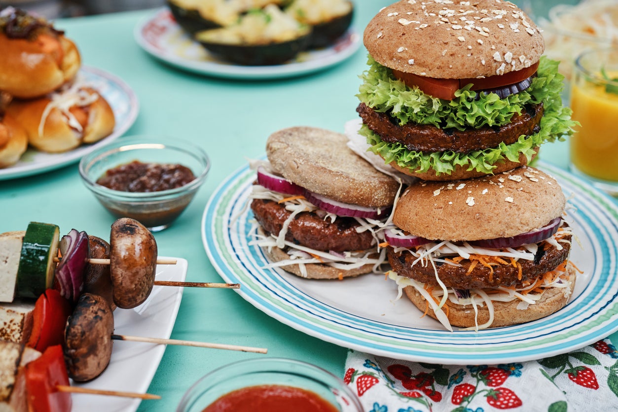 Roasting Vegan Skewers, Vegan Burger Patties and Vegetables on BBQ Grill
