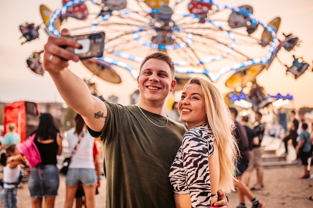 Couple making selfie in amusement park