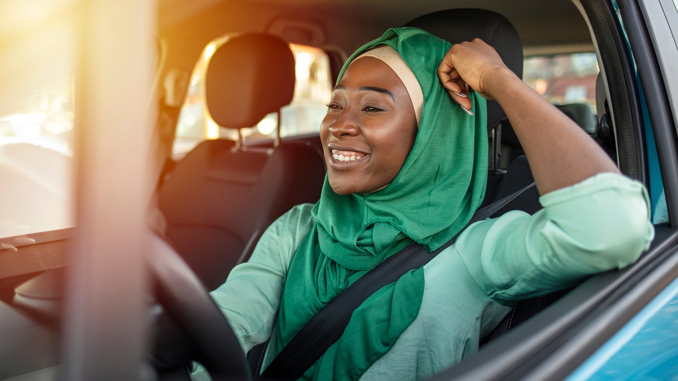 Young African Muslim woman driving a car.