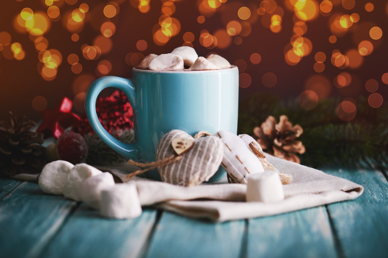 Blue mug filled with hot chocolate with marshmallow candies