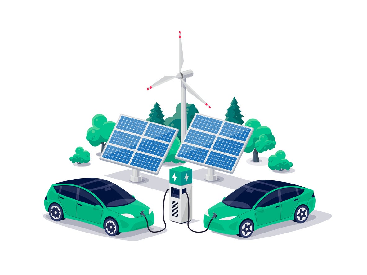 Electric cars charging on green renewable solar wind energy charger station with charging stall