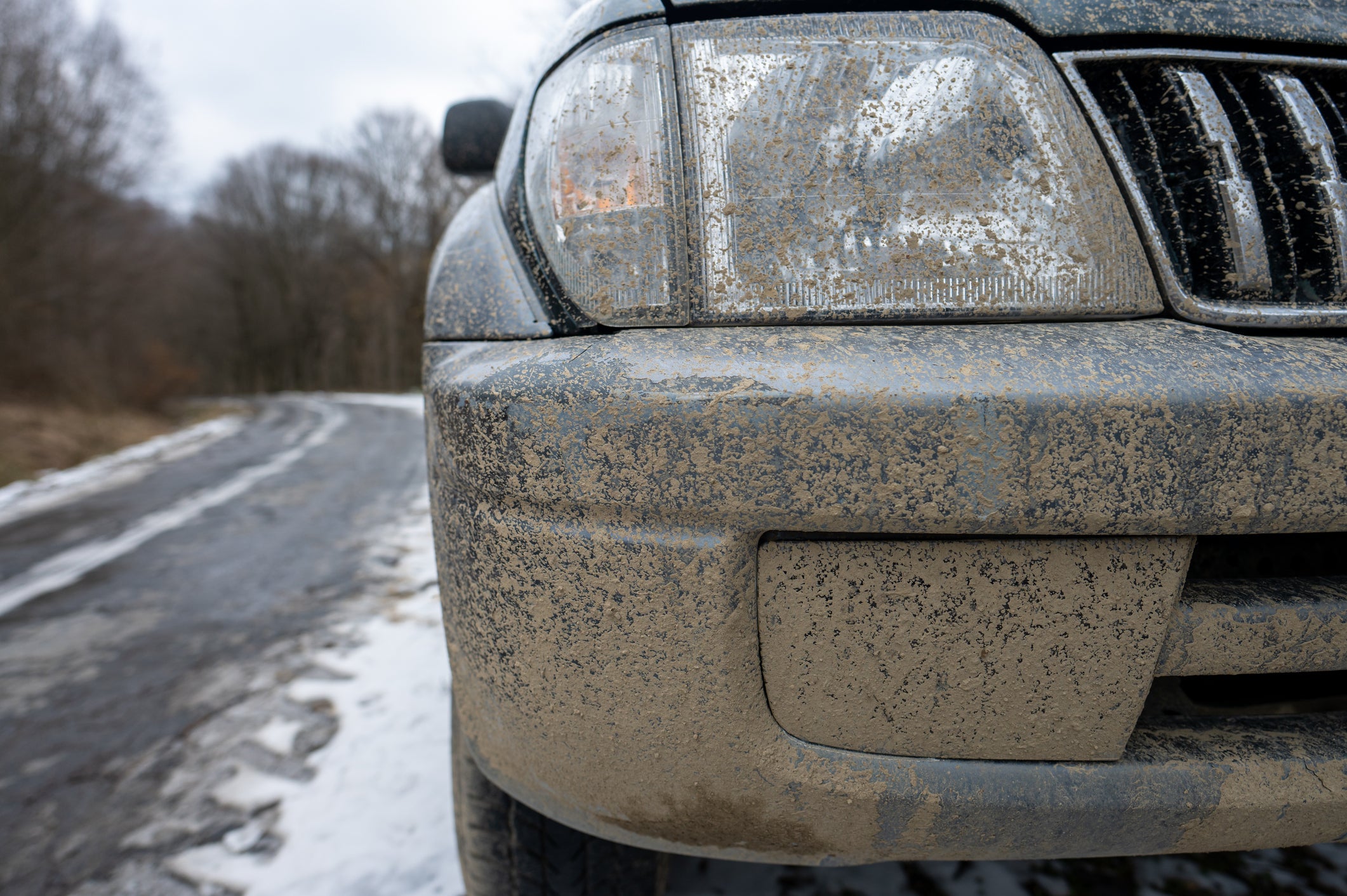 Dirty car headlights Adventure background. Detail of dirty off-road car.