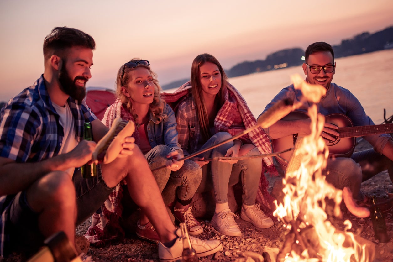Group of young friends having fun together on the beach