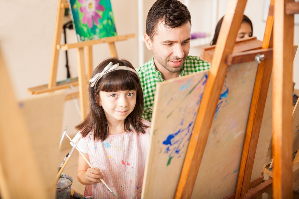 Pretty girl and her teacher in art class