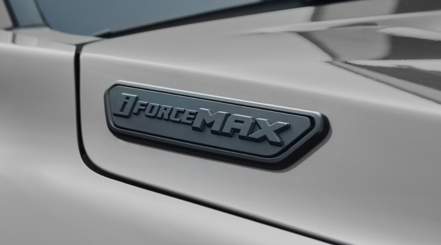 Close up of the matte black i-FORCE MAX hybrid emblem on the fender of a silver 2026 Toyota Tacoma at Classic Toyota in Waukegan, Illinois 