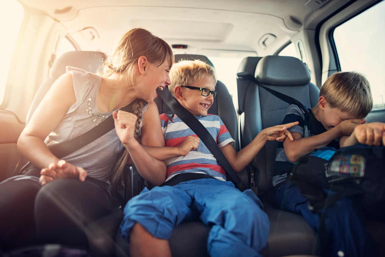 Happy kids travelling by car