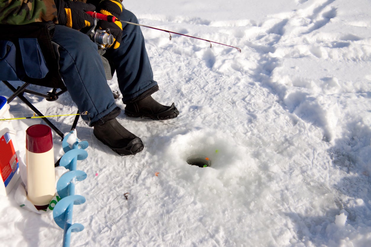 Ice fisherman waiting for a catch