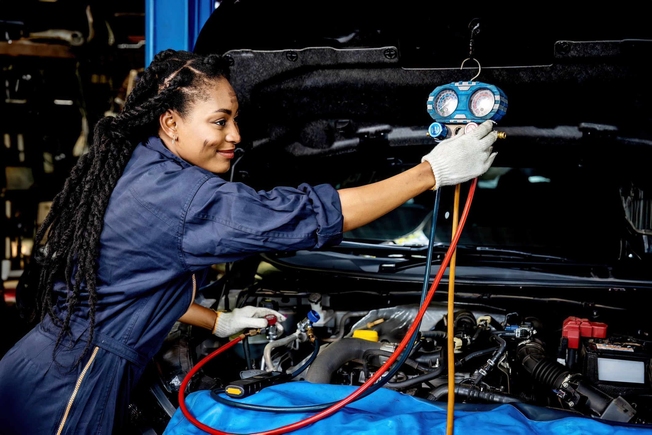 Auto mechanic monitor to check and fixed car air conditioner system in car garage. service car air conditioner in repair workshop. monitor tool on car engine ready to check and fixed air conditioner