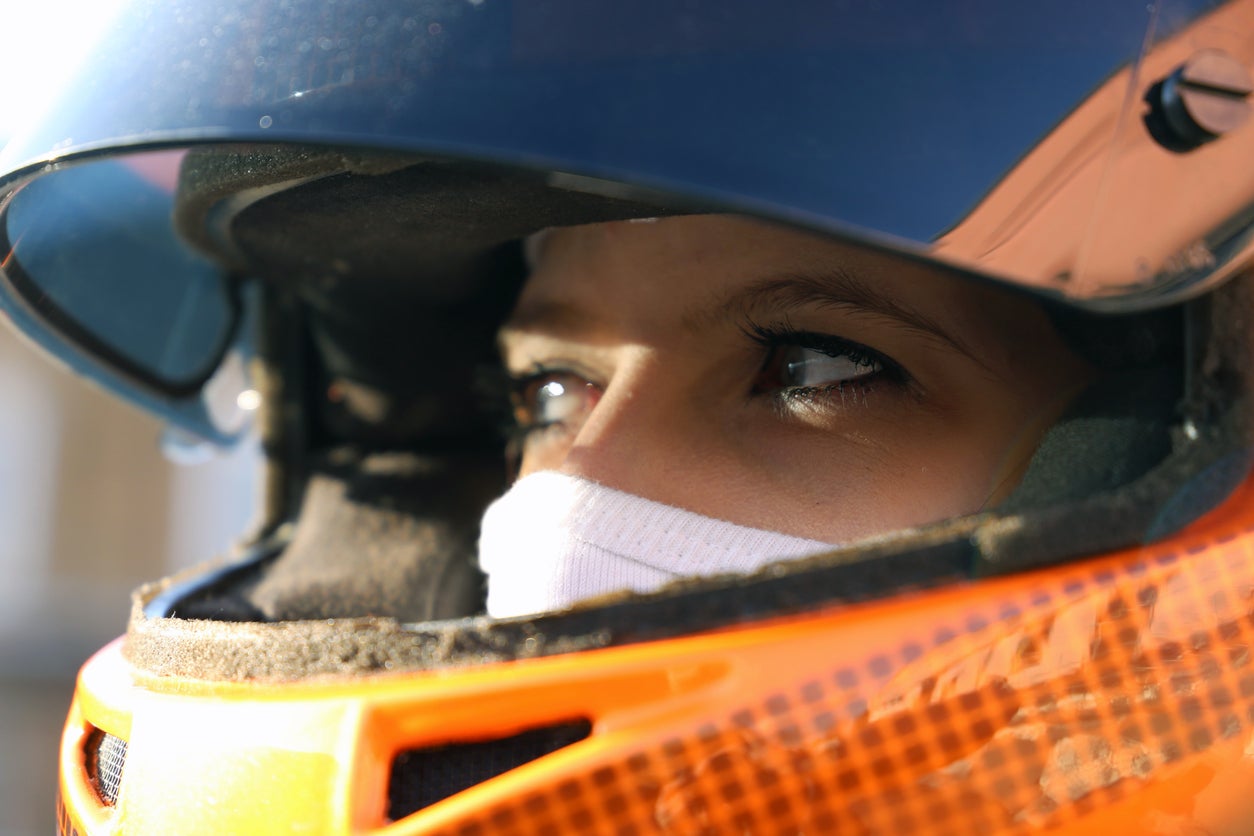 Symbol image: Female race car driver wears helmet and balaclava (Model released)