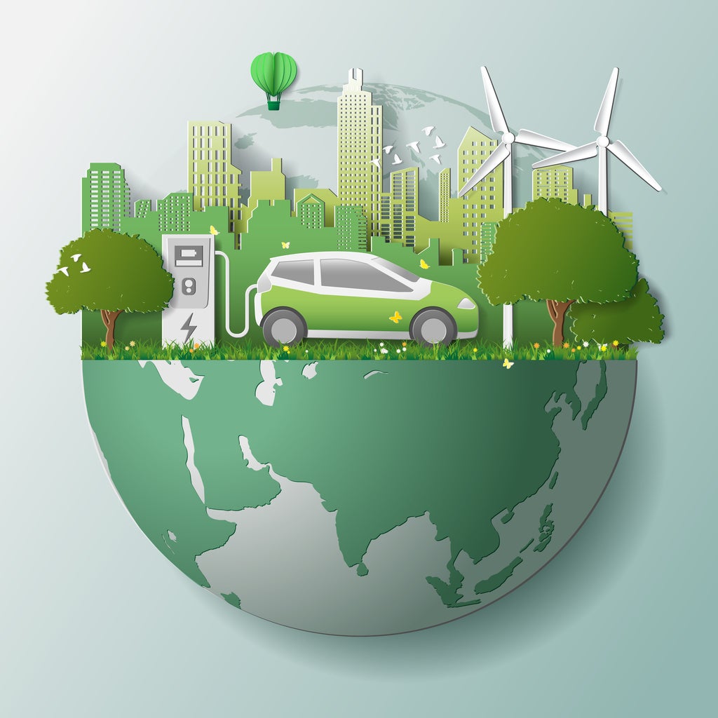 Green renewable energy ecology technology power saving environmentally friendly concepts, electric car at charging station beautiful park city background on globe