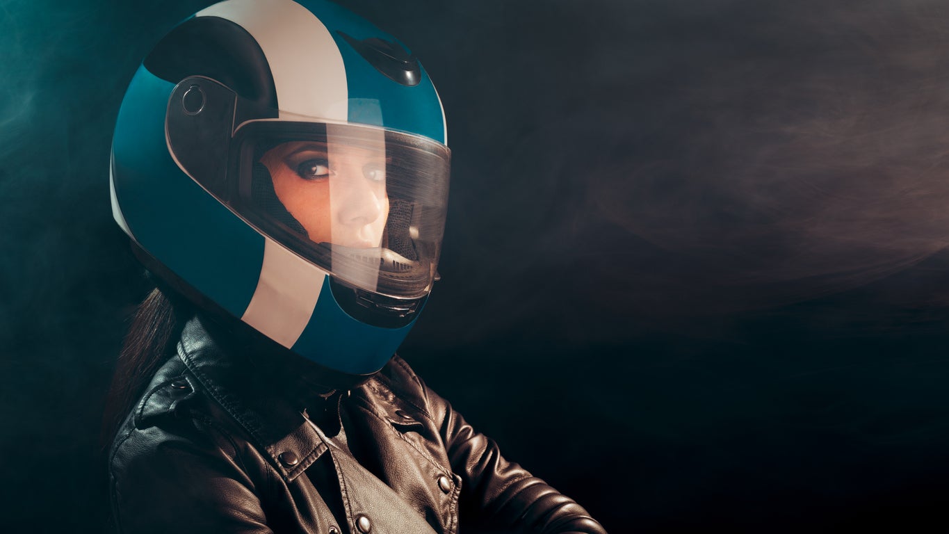 Biker Woman with Helmet and Leather Outfit Portrait