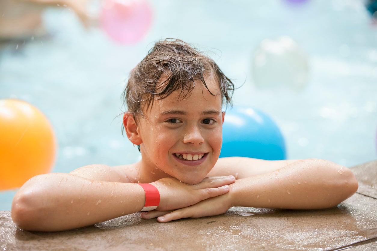 Young boy playing at the indoor water park
