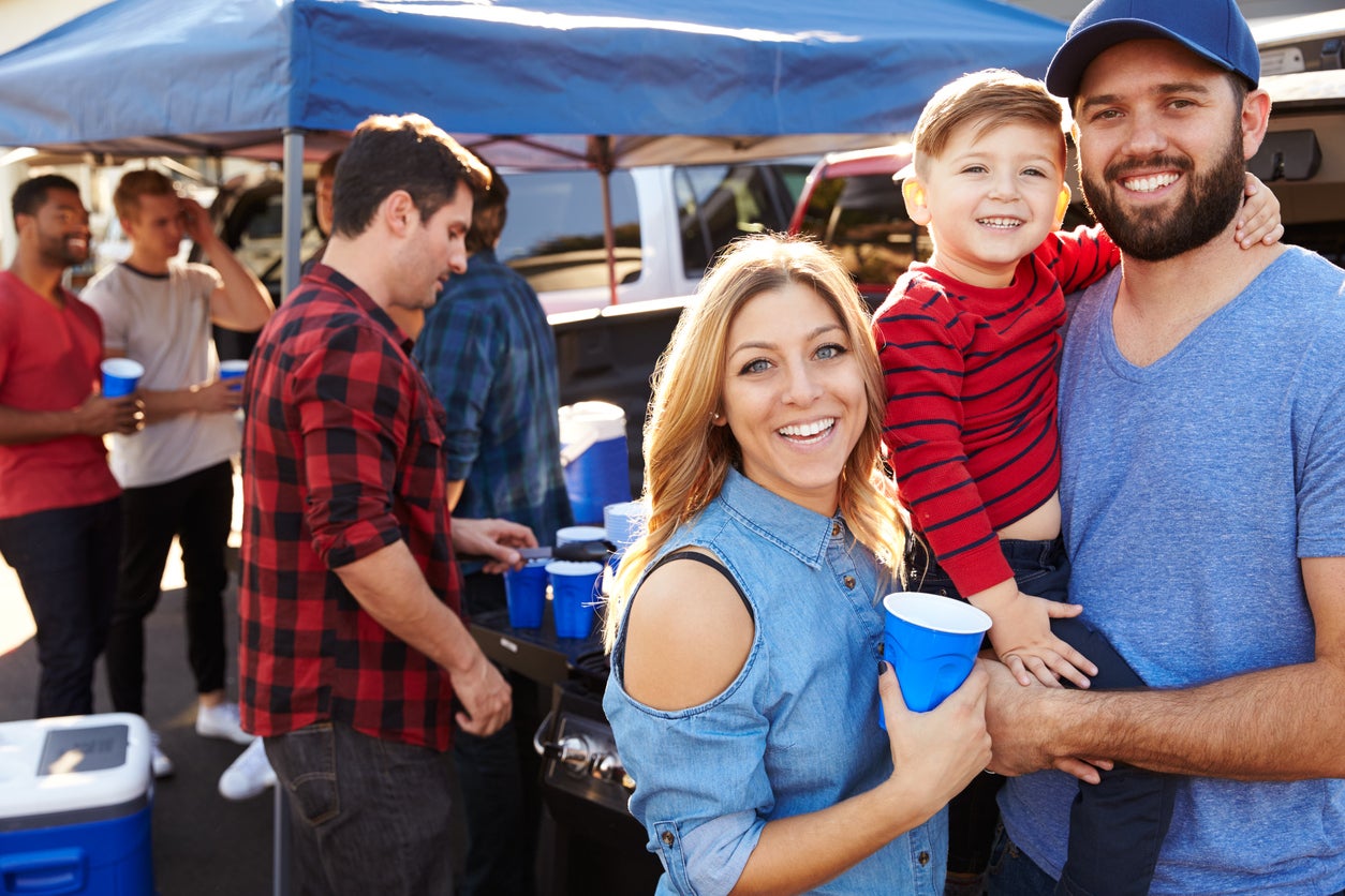 Portrait Of Family Group Tailgating In Stadium Car Park