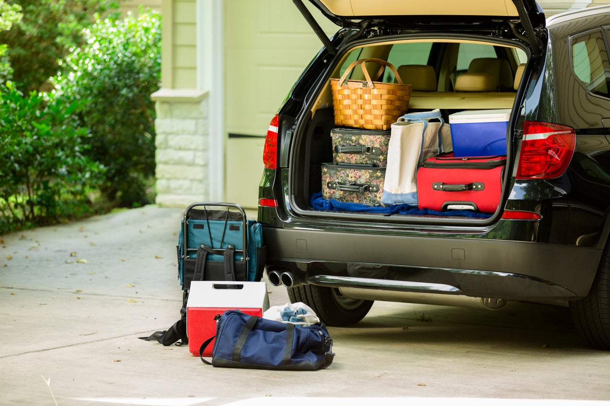 Family vehicle packed, ready for road trip, vacation outside home.