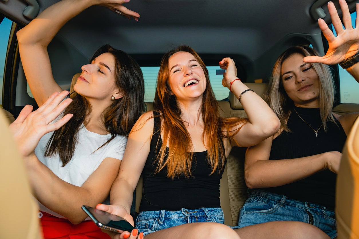 Happy young women enjoy car ride together