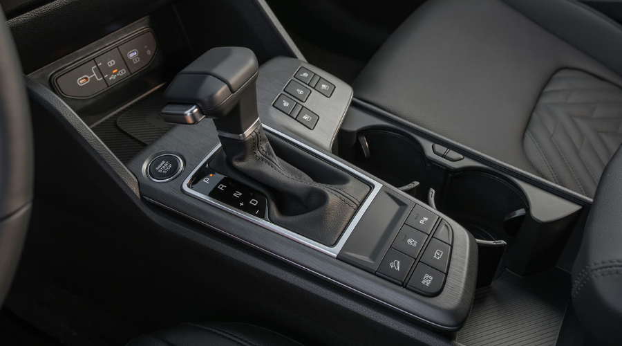 Close-up view of the 2026 Kia Sportage Terrain Mode dial on the center console in Classic Kia showroom.