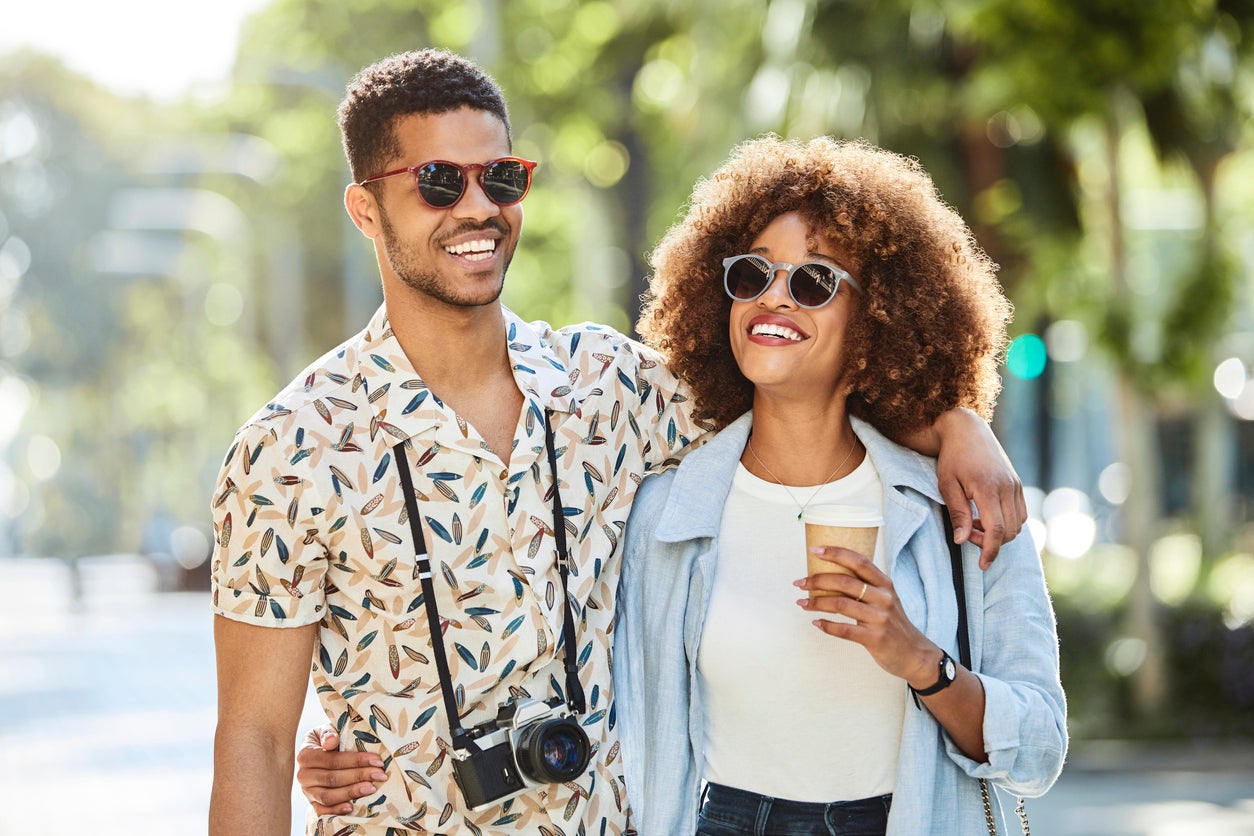 Couple walking arm around on sidewalk in city
