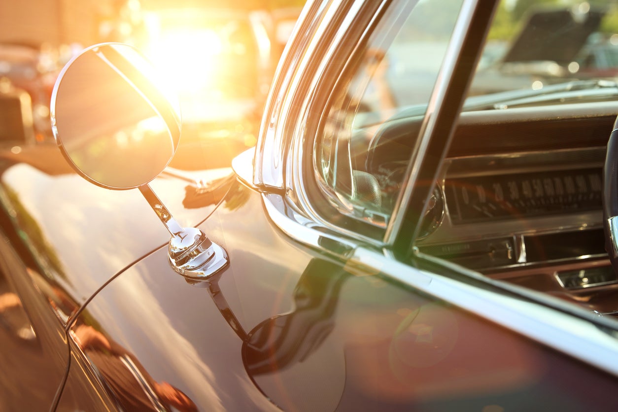 classic retro vintage black car. Car mirror. The car is older than 1985