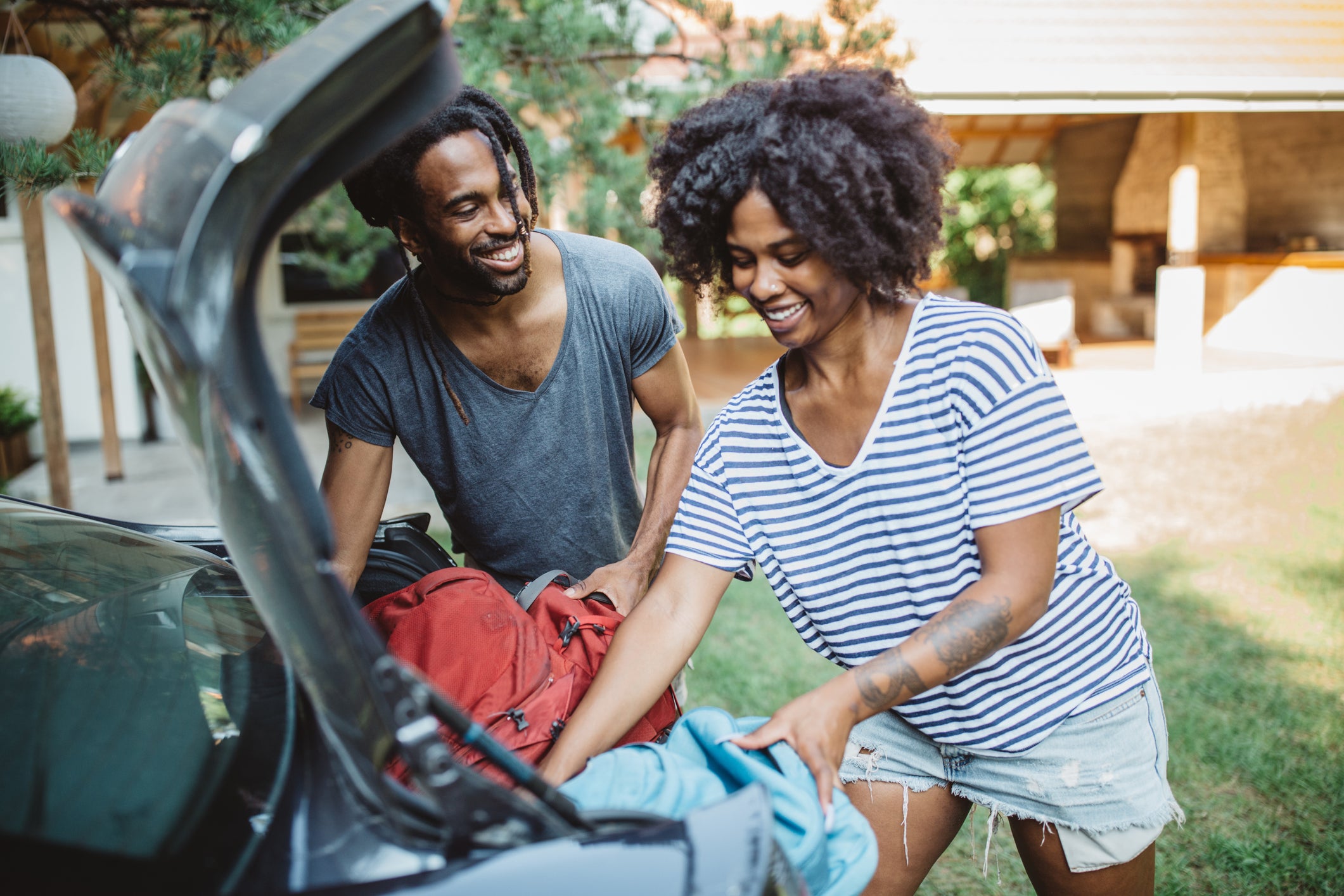 Couple loading a car.