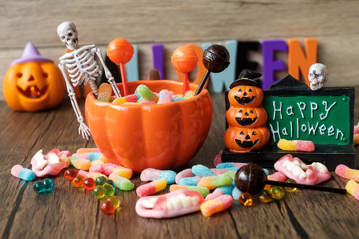 Happy Halloween day with ghost candies, pumpkin bowl, Jack O lantern and decorative (selective focus). Trick or Threat, Hello October, fall autumn, Festive, party and holiday concept