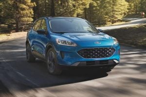 A blue 2022 Ford Escape driving on a road.