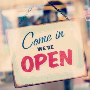 Come on in sign, "We're Open".