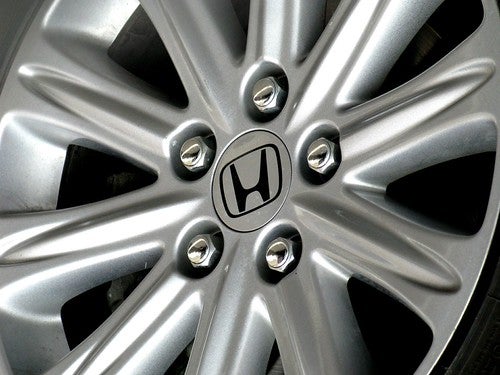Close on wheel of Honda Civic with Honda logo in middle