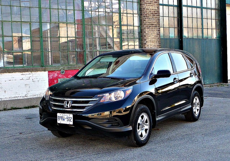 Dark blue Honda CR-V in front of industrial building