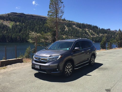 Honda Pilot on a road with a river in the background