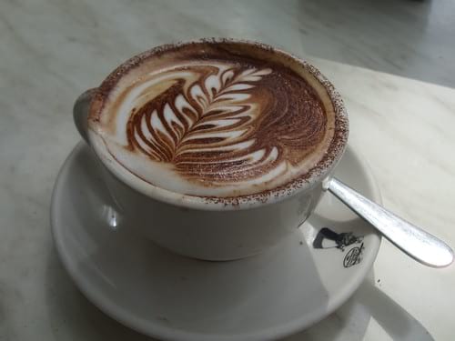 Espresso drink with latte art on plate