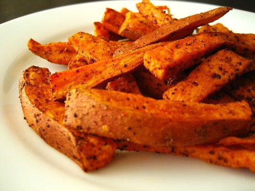 Sweet potato fries covered in heavy seasoning