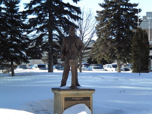 Statue of Alexander Griggs surrounded by snow - Grand Forks Statue